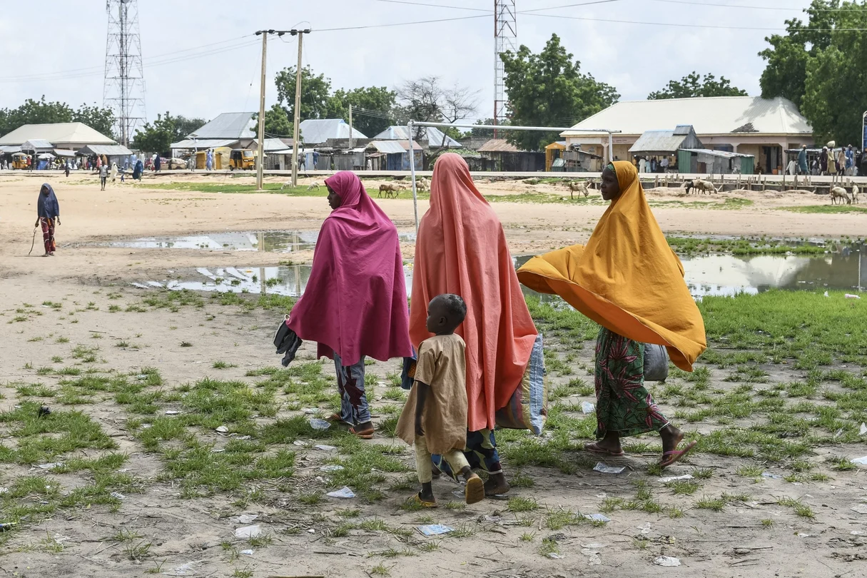 Survivors and relatives of victims of a suspected Boko Haram attack walk in Babban Gide on September 4, 2024. At least 81 people died and several are missing following an assault by suspected Boko Haram jihadists in Yobe State, northeastern Nigeria.
