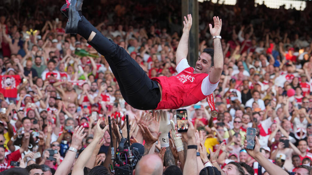 Arsenal manager Mikel Arteta is carried in triumph by his players as they celebrate winning the Premier League title following the English Premier League match between Crystal Palace and Arsenal in London, England, Sunday, May 24, 2026.