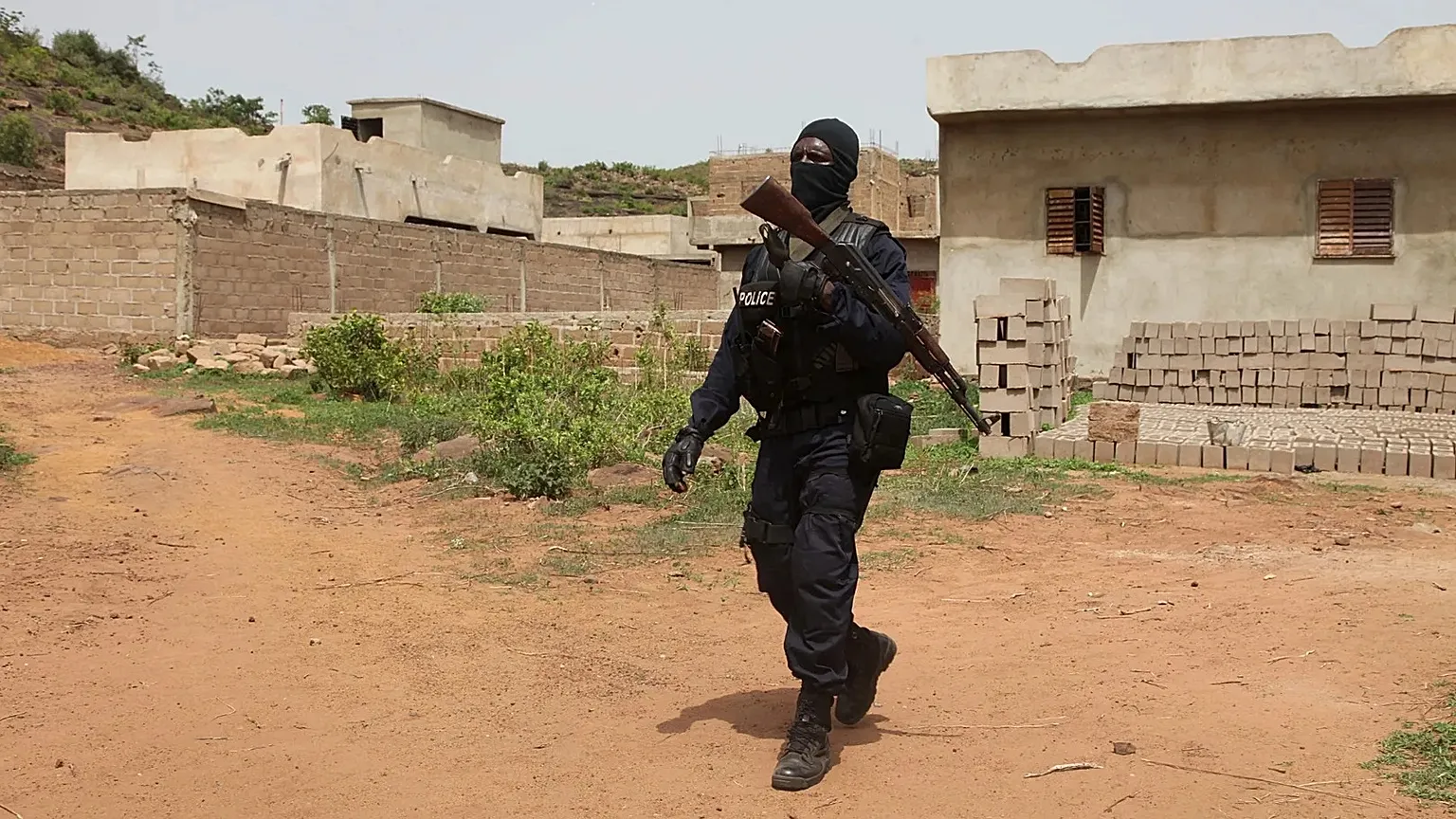 A Malian police officer patrols near the Kangaba Campement, a tourist complex near Bamako, June 19, 2017