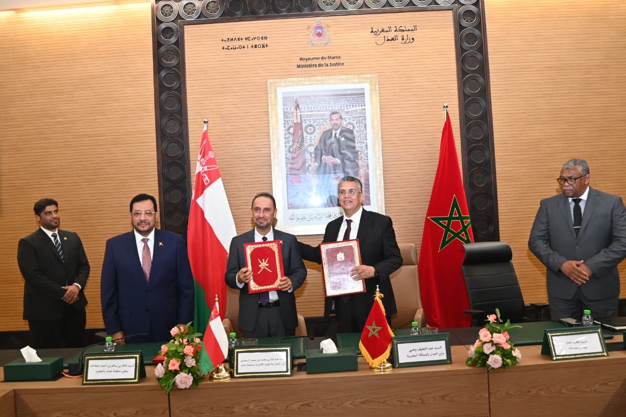 Moroccan and Omani officials signing judicial cooperation agreement