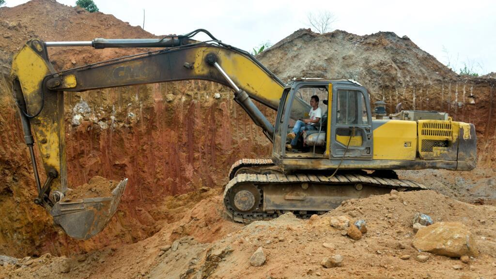 A Chinese employee operates a bulldozer at a mining site in Betare Oya, Cameroon, on April 4, 2018.